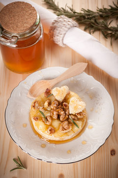 Baked cheese Camembert  with honey, nuts and herbs