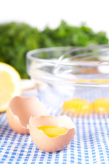 Broken eggs in bowl with lemon