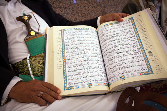 Korans in the hands of a Muslim