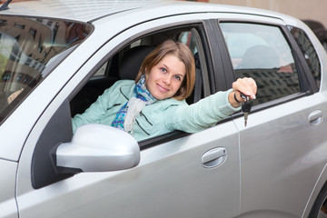 Blond hair woman showing ignition key