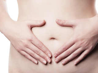 Young woman holding her belly - isolated