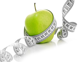 Measuring tape wrapped around a green apple - 45824290