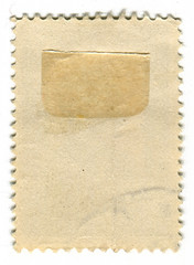 The reverse side of a postage stamp.