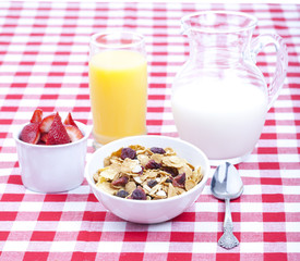 Breakfast of cereal, fruit, orange juice and milk