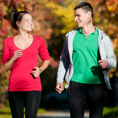 Young man and woman running