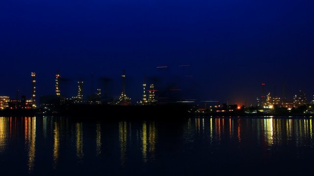 River and oil refinery factory with reflection
