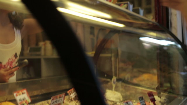 Young tourist couple buying an ice cream, steadycam shot