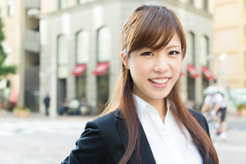 Beautiful business woman walking outside her office