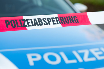 Absperrband vor Polizeiauto