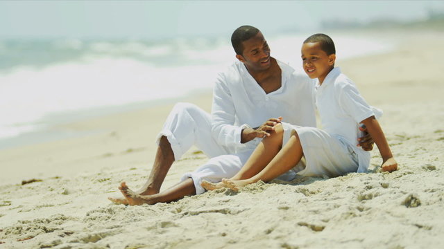 Ethnic boy chilling together loving father on beach 