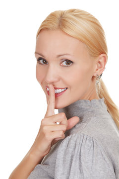 happy woman with finger on lips