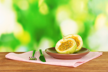 Green passion fruit in the plate on bright green background