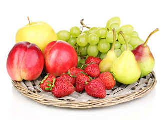 ripe sweet fruits and berries on wicker mat isolated on white