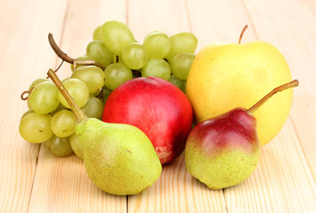 ripe sweet fruits and berries on wooden background