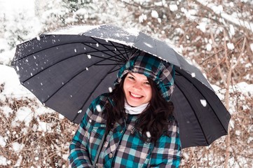 Girl with umbrella in the snow