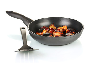 roasted chestnuts in the pan isolated on white