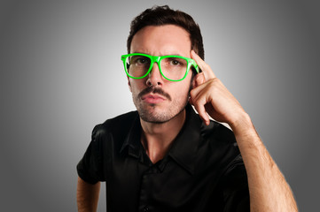 thoughtful man with green eyeglasses