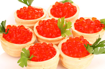 Red caviar in tartlets on white plate close-up