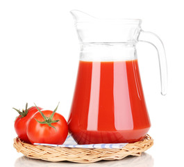 Tomato juice in pitcher on wicker mat isolated on white