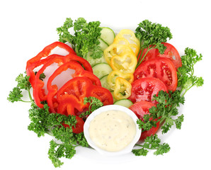 Chopped vegetables and sauce on plate isolated on white