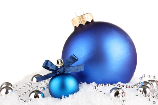 beautiful blue Christmas balls on snow, isolated on white