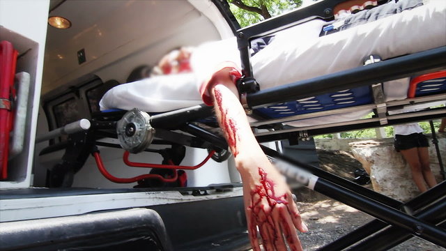 Accident and Wounded girl carried by ambulance