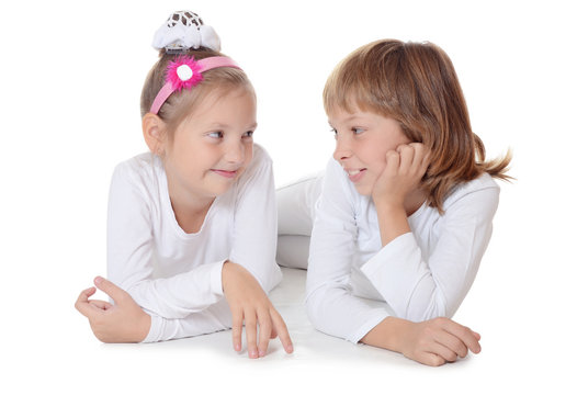 Two young girl friends on white background
