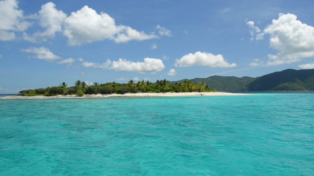 Tropical paradise with sailboat and island in the Caribbean