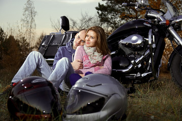 Smiling couple on motorcycle