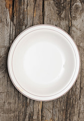 single white plate on old wood background
