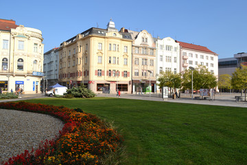Naklejka premium Historic buildings on the square with lawn