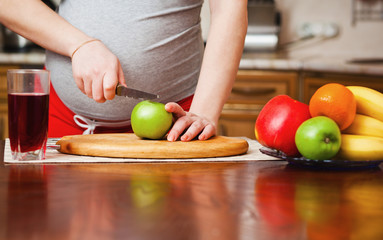 beautiful pregnant woman on kitchen