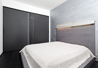 Fototapeta na wymiar Modern minimalism style bedroom interior in beige tones