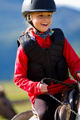 Horse riding - portrait of lovely equestrian on a horse