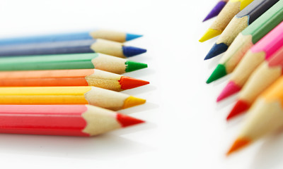 Row of colored pencils, on white background
