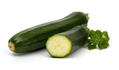 Cut zucchini courgette with parsley isolated on white background