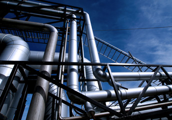 Industrial zone, Steel pipelines and valves against blue sky