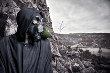 Portrait of a man in a gas mask and hood
