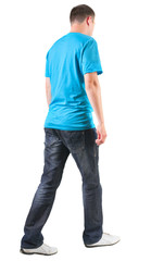 Back view of walking handsome man in t-shirt.