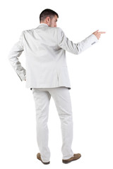 Back view of businessman pointing at wall