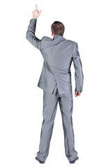 Back view of businessman pointing at wall.