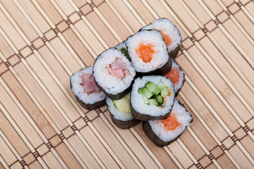 closeup sushi roll on bamboo mat