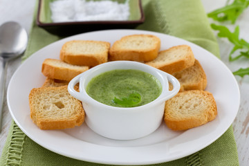 sauce in white bowl with toasts