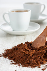 Freshly ground coffee and a cup