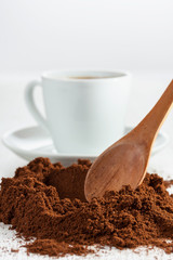 Freshly ground coffee and a cup