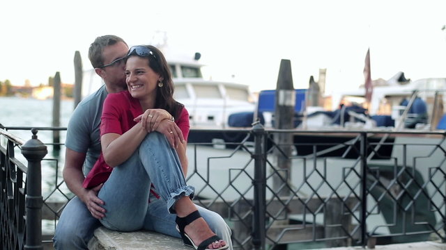 Couple in love hugging and kissing in Venice, steadycam shot 