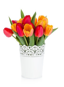Red and orange tulips in flowerpot