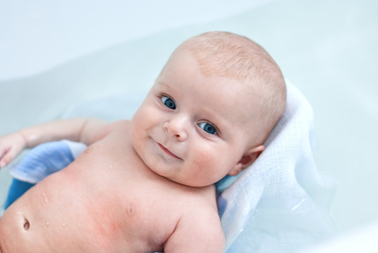 Little baby boy taking bath in bathtub
