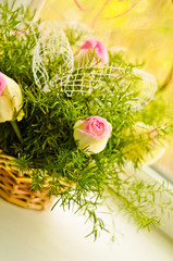 Beautiful bouquet of white and pink roses in a basket