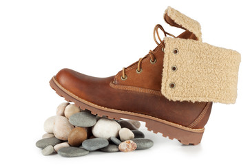 Brown shoe on sea stones isolated on white background